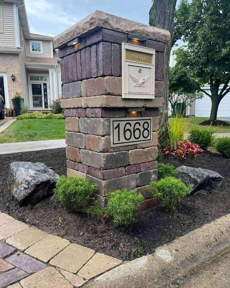 Mailbox encased in brick pillar