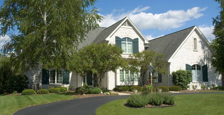 White house with new asphalt driveway