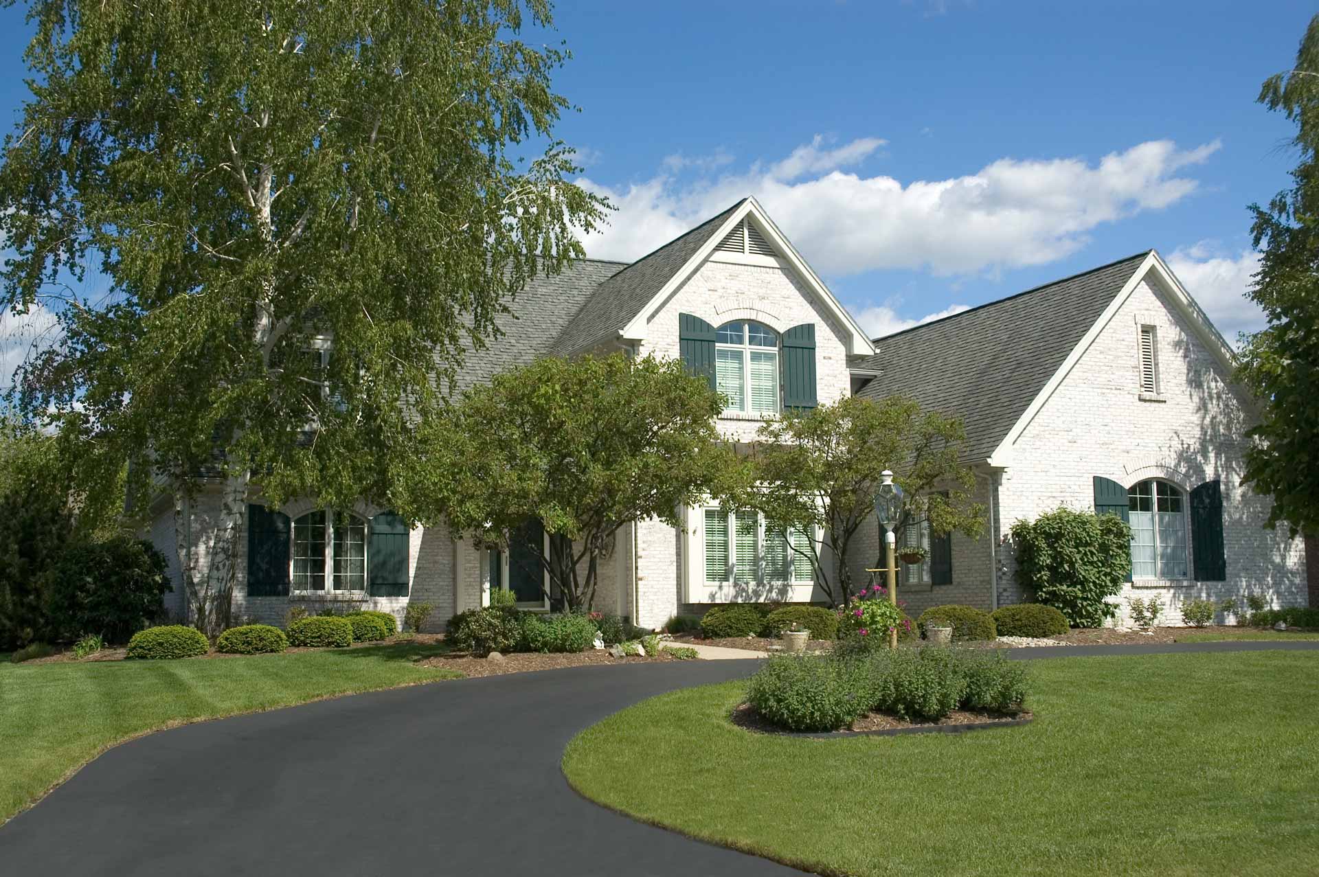 White house with new asphalt driveway