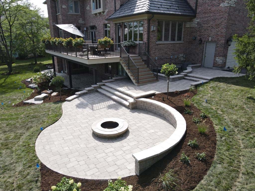 Newly paved backyard with built-in fire pit
