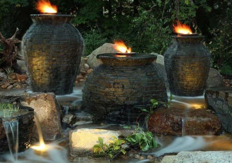 Three stone lanterns in a small backyard waterfall